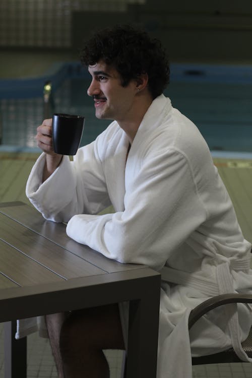 A Man Sitting with a Mug 