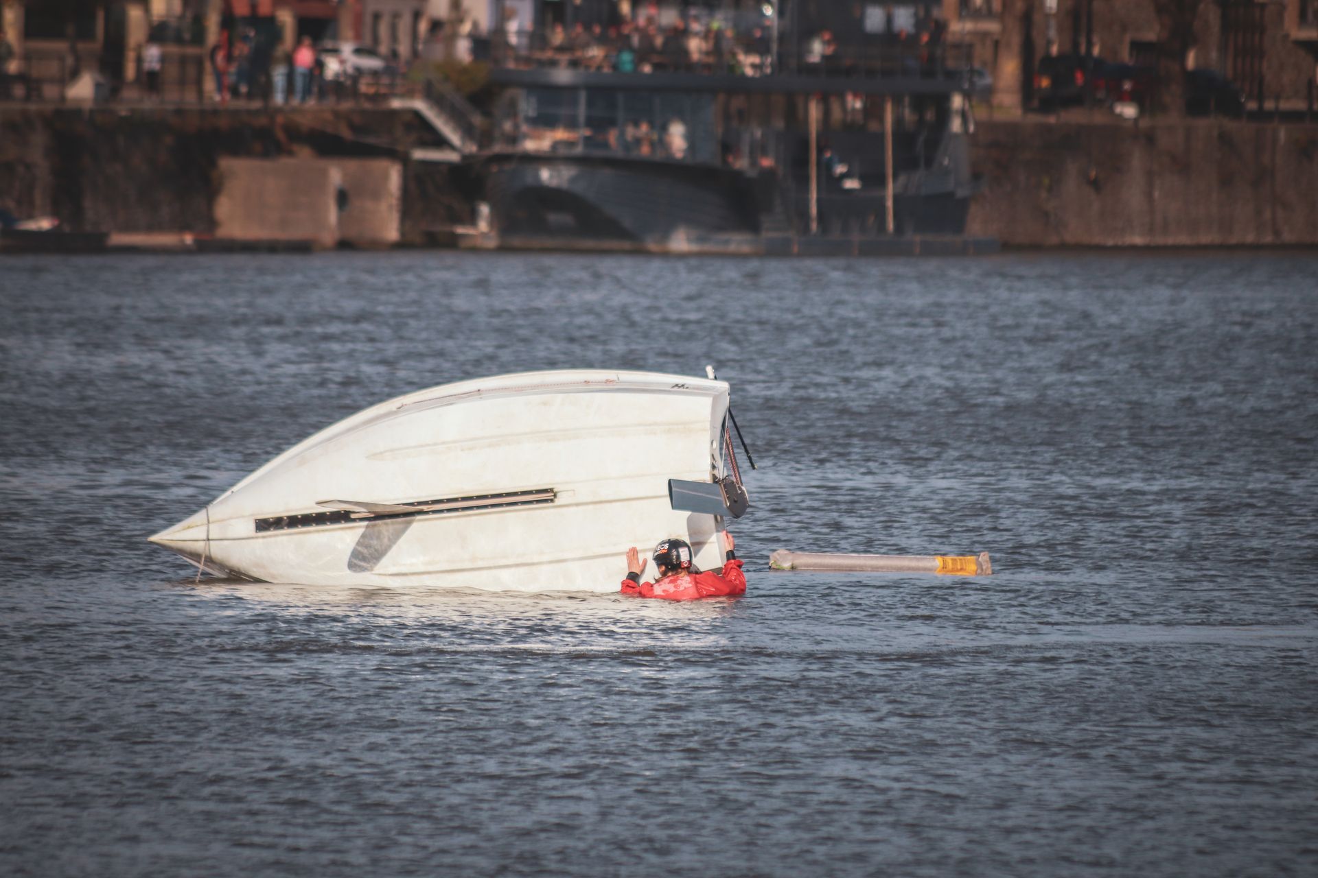 A Fallen Boat on the Water Surface in the Harbor
