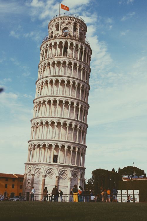 Free The famous Leaning Tower of Pisa with tourists in a sunny day in Tuscany, Italy. Stock Photo