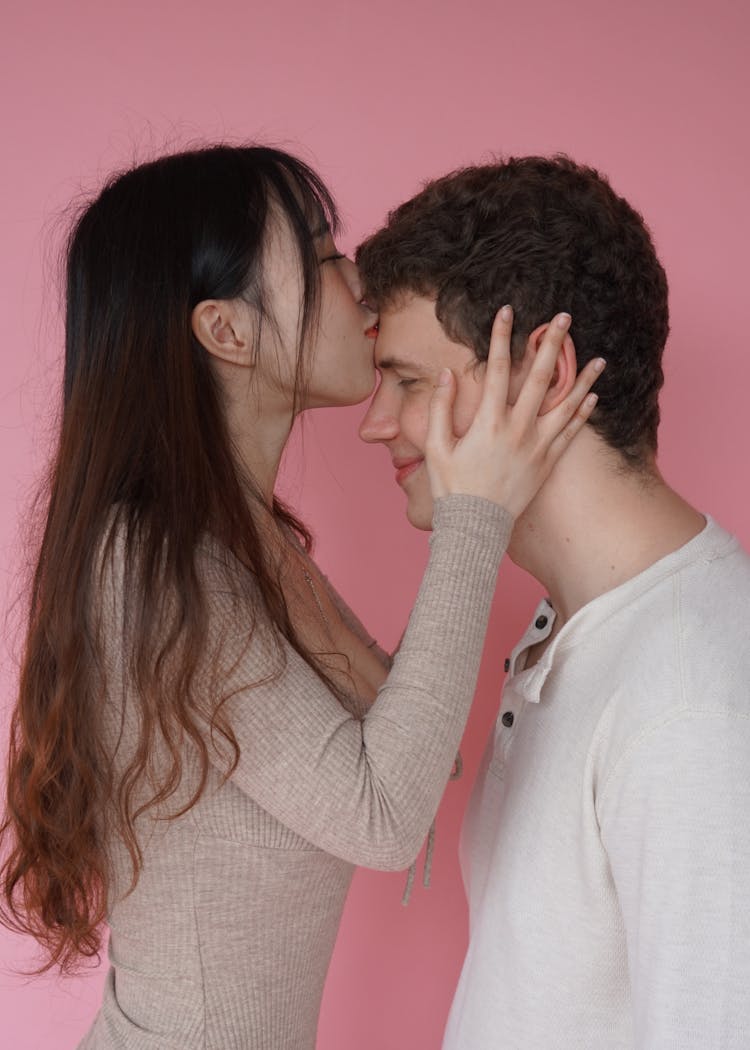 Woman Kissing Man On Forehead