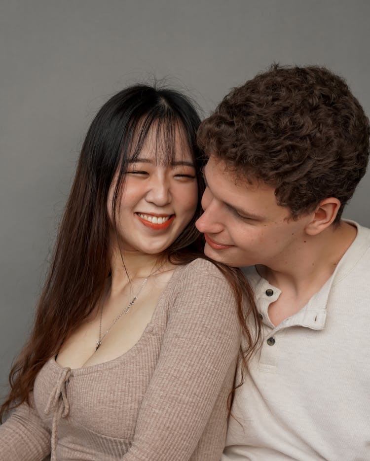 Smiling Interracial Couple Posing On Grey Background