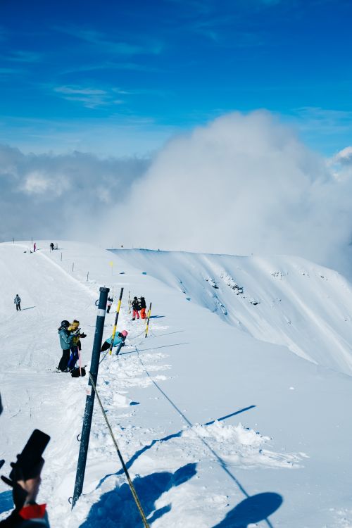 Free Experience an exhilarating day at a mountain ski resort with vibrant blue skies and fresh snow. Stock Photo