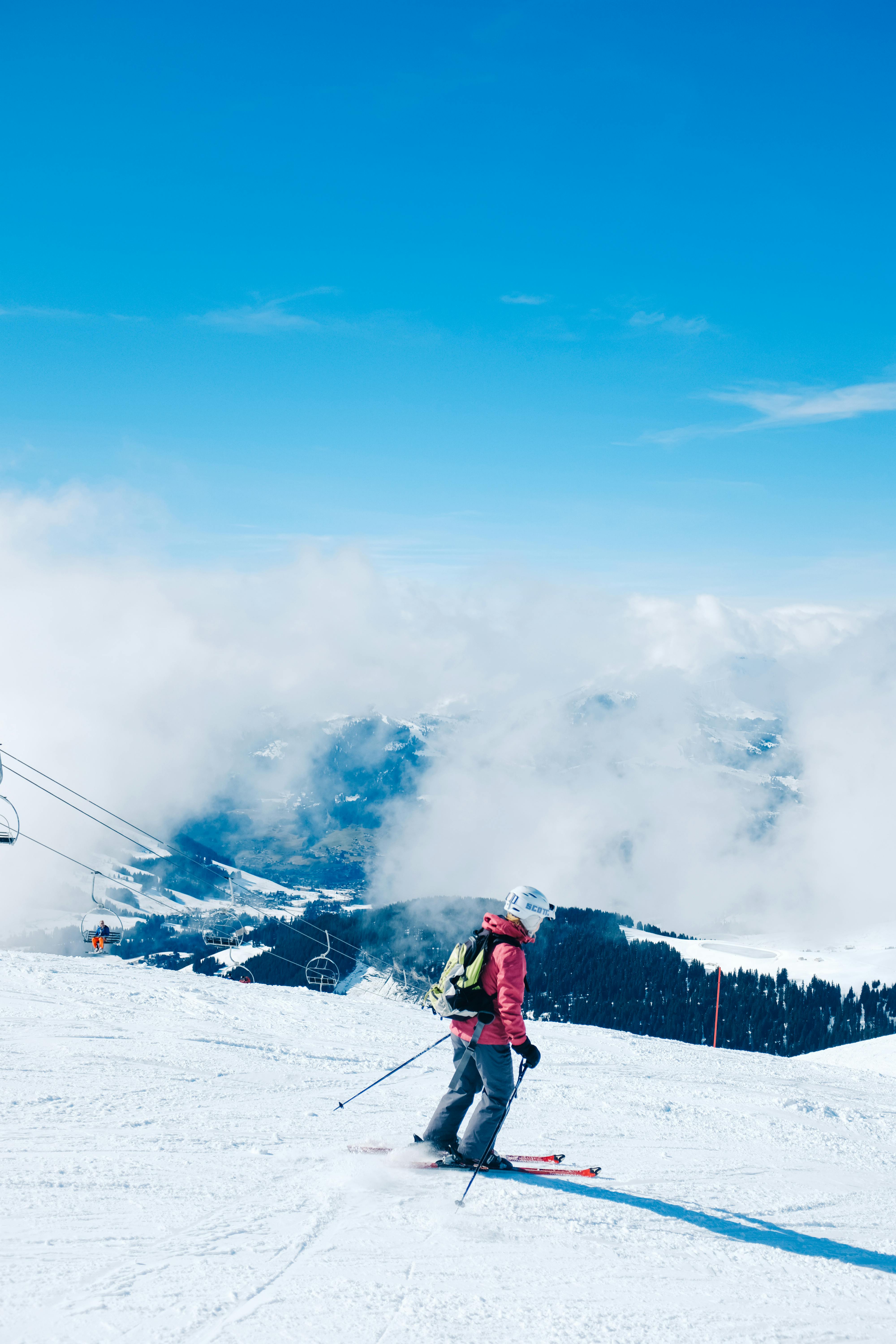 Prescription Goggle Inserts - A skier gracefully skiing down a snow-covered mountain on a sunny winter day.