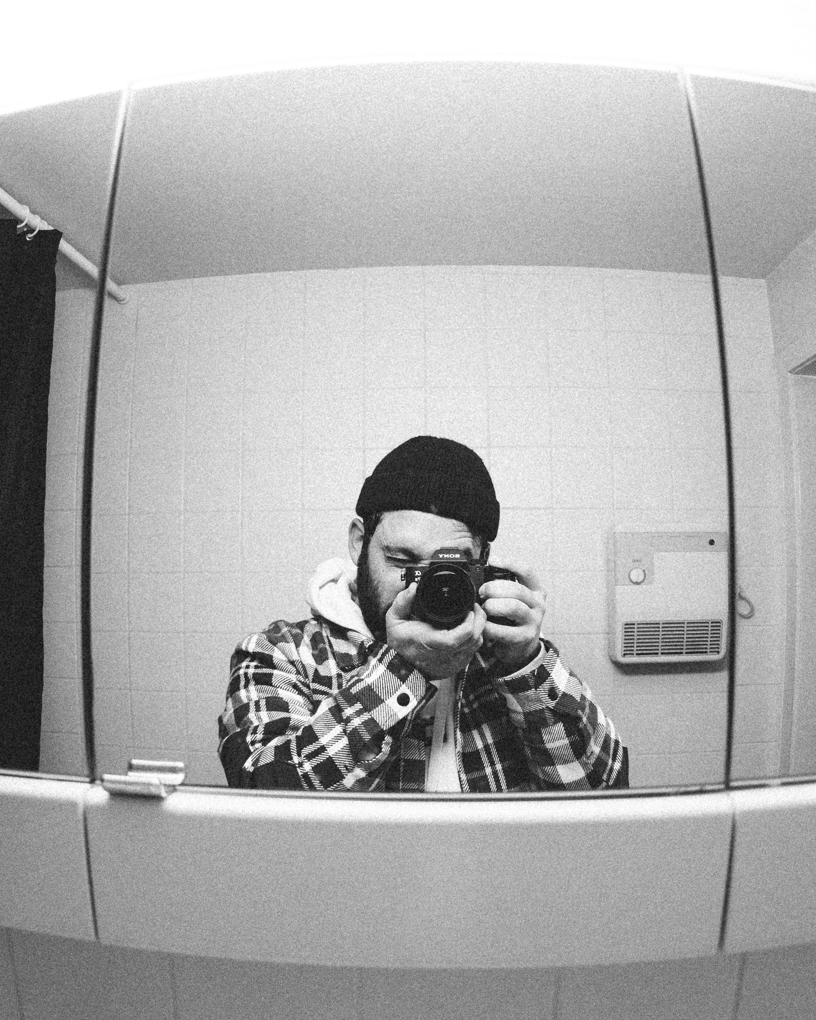 A Person Taking a Picture in a Mirror · Free Stock Photo
