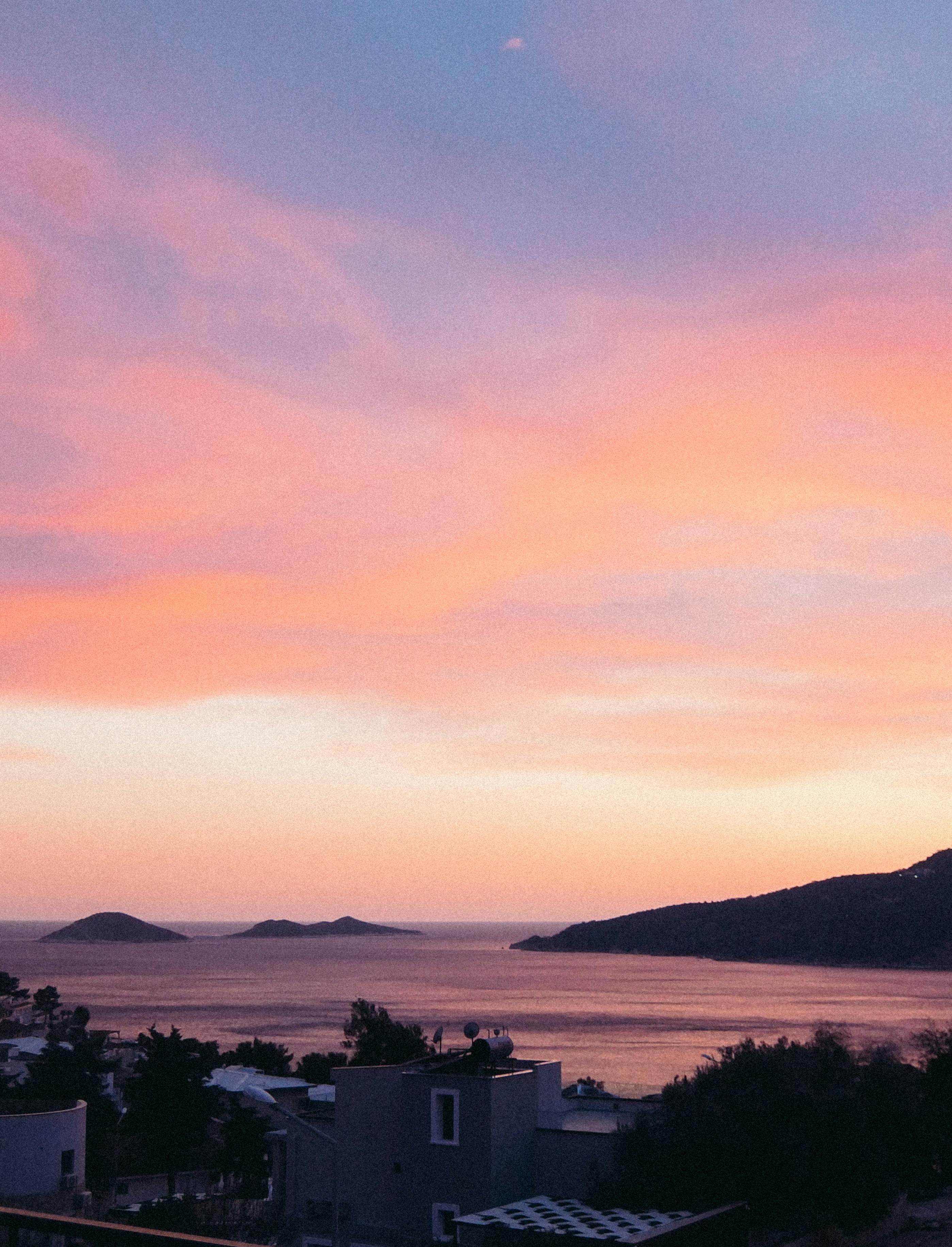 Delightful view of the ocean at sunset with islands and colorful sky. Perfect travel and nature scene.