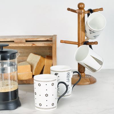 Patterned mugs on a mug tree — Ajit Bari on Pexels