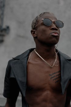 Portrait of a fashionable man with sunglasses, showcasing modern street style in Milan.