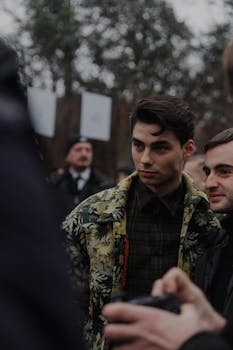 Candid street fashion scene at a Milan event with stylish young adults.
