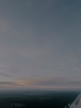 Aerial view of the Kalngale coastline at twilight with expansive sky and dark horizon.