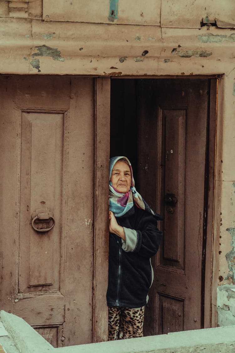 Elderly Woman Standing In Door