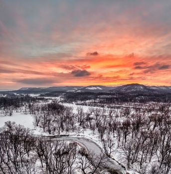Captivating winter landscape in Weaver, MN, at sunset, featuring snow-covered fields and a dramatic sky.