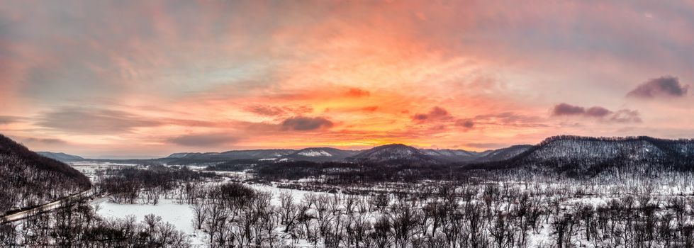 Breathtaking winter sunset over snow-covered Weaver mountains, Minnesota.