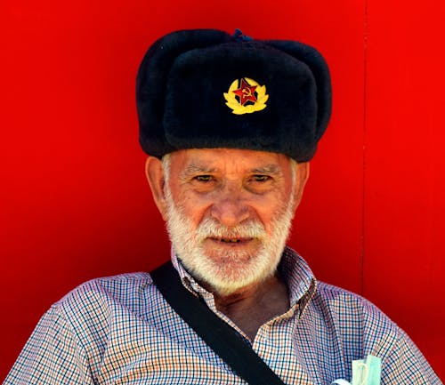 Portrait of an Eldery Man in a Military Cap 