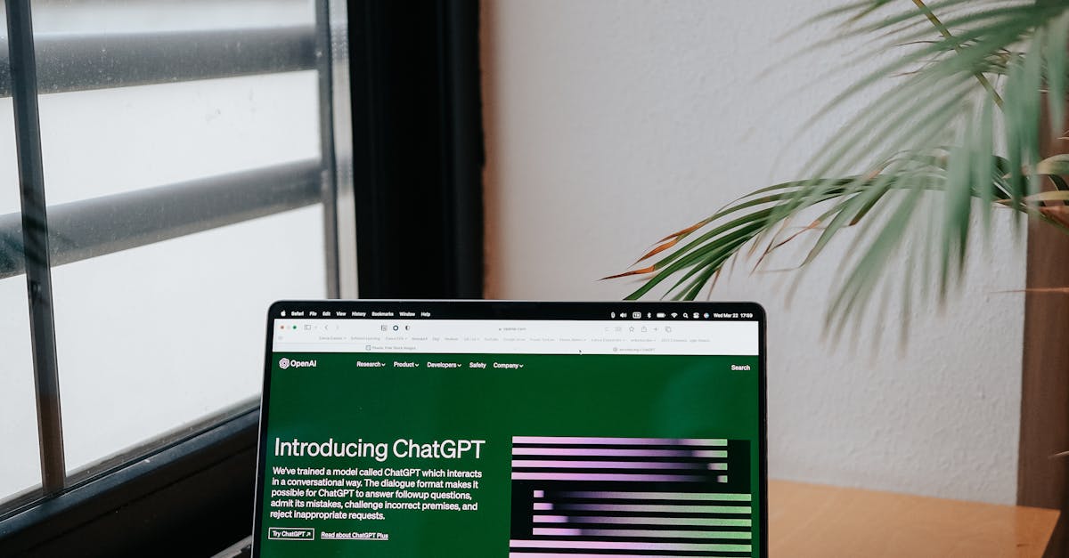 Photo by Hatice Baran Open laptop on desk shows ChatGPT AI interface, adjacent to a large window.