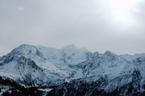 Landscape with Rocky Mountains in Snow, and Overcast in Sky