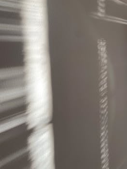 Blurred abstract patterns of light and shadow creating a textured effect.