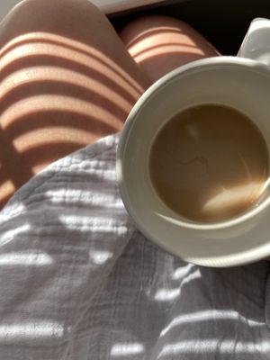 Cup of coffee casting shadows on linens by Kiersten Williams on Pexels