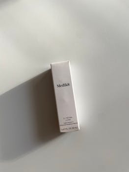 Elegant minimalist presentation of Medk8 skincare packaging with soft shadow contrast.