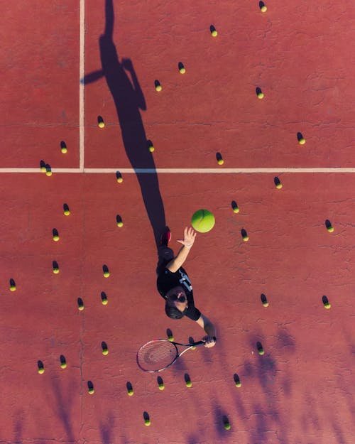 Tennis Player Serving Ball