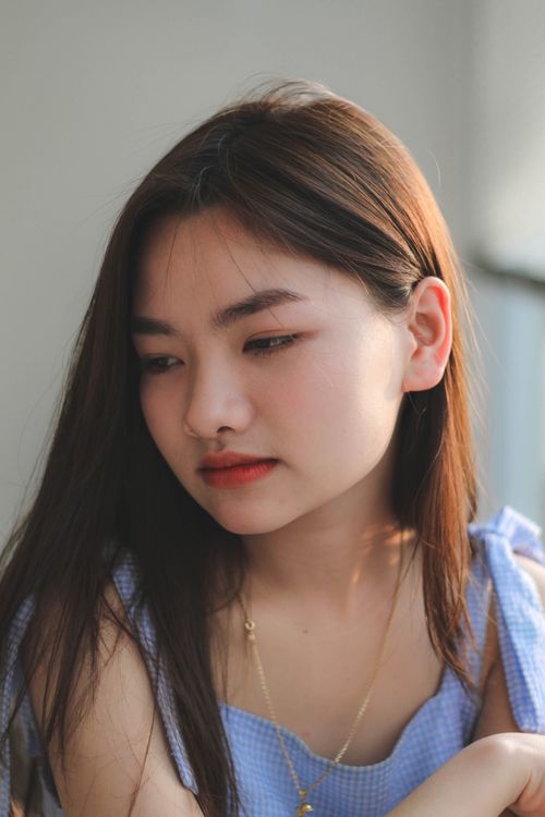 Free Portrait of a teenage girl with long brown hair and calm expression. Stock Photo