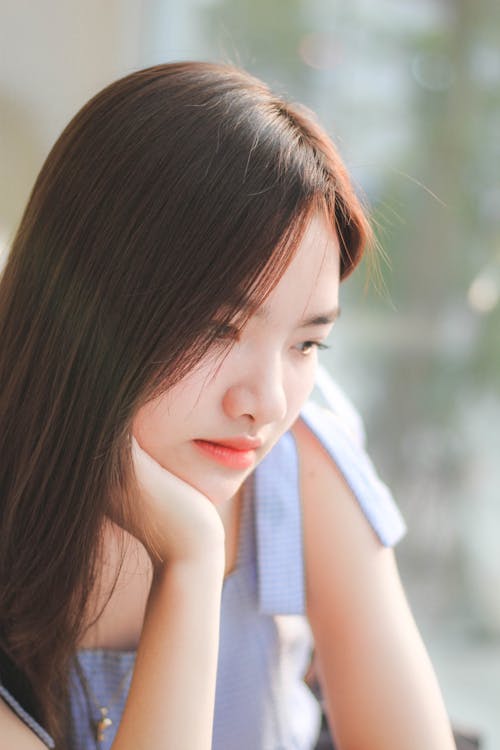 Young Woman Resting Her Head on Her Hand