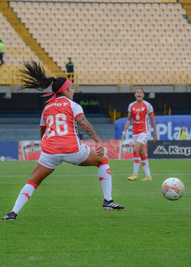 Women Playing Football On Stadium