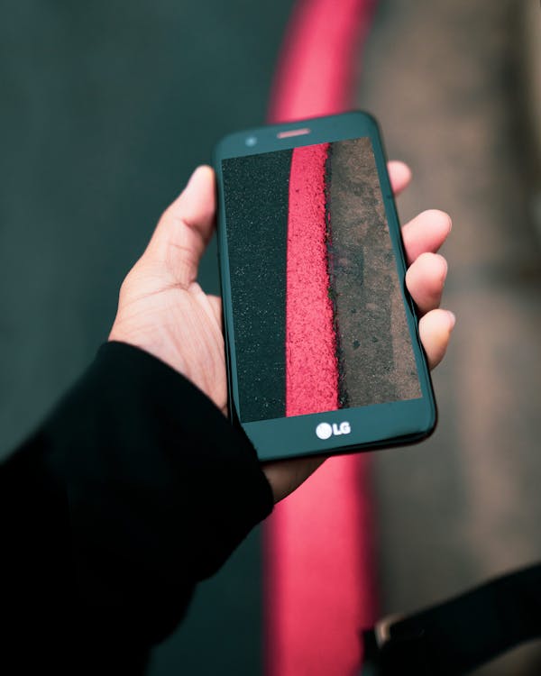 Person Taking Photo of Red Textile