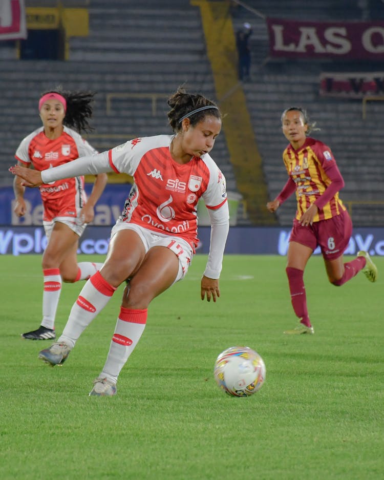 Women Playing Football On Stadium