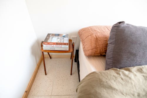 A bed with a pillow and a book on it