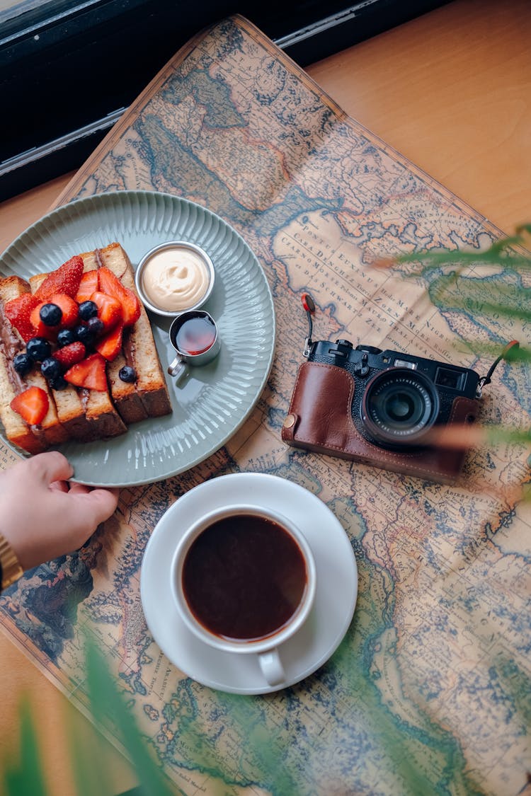 Toasts With Fruits And Black Coffee On Retro Newspaper