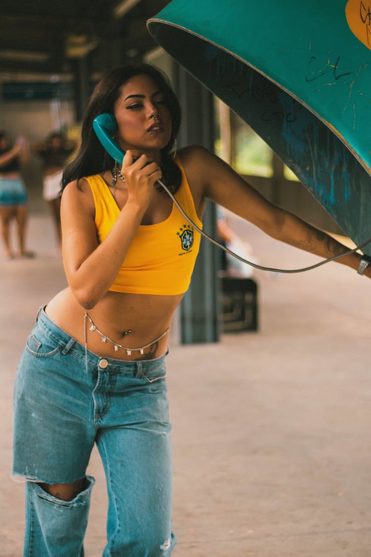 Woman Wearing Jeans, Using Telephone Box