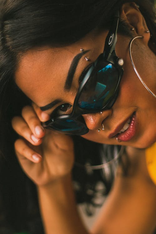 Closeup of a Woman with Piercing, Wearing Sunglasses
