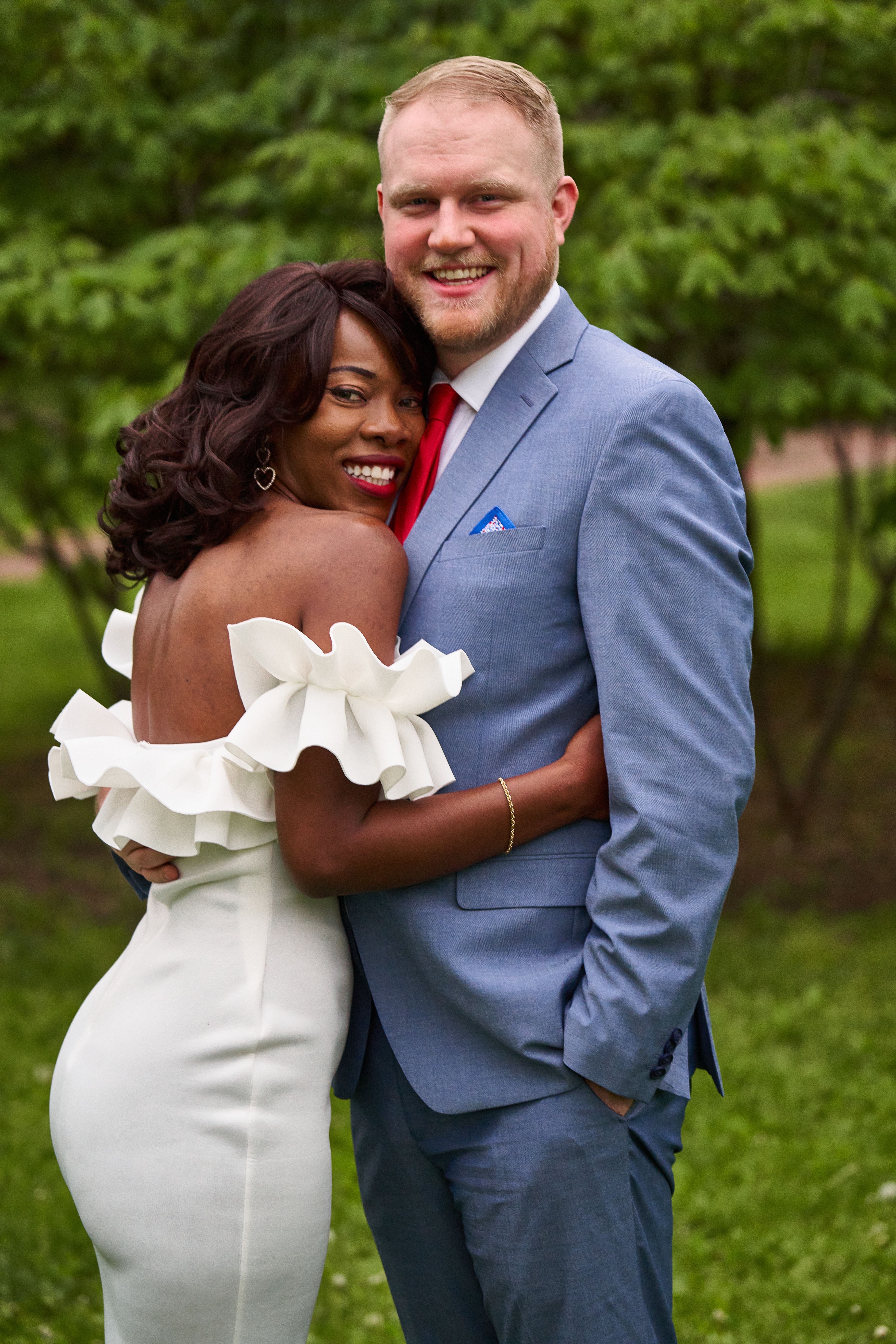 Photo of the Bride Embracing the Groom in a Park · Free Stock Photo