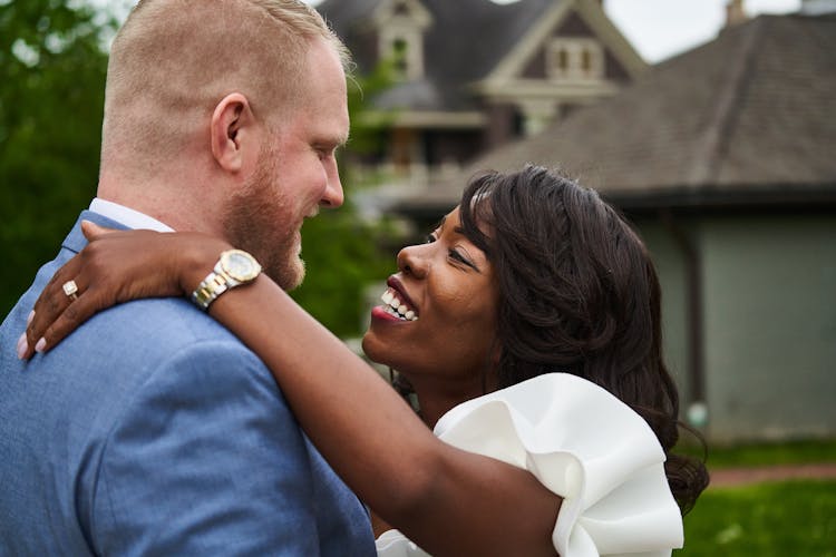 Wedding Couple Embracing On A Yard