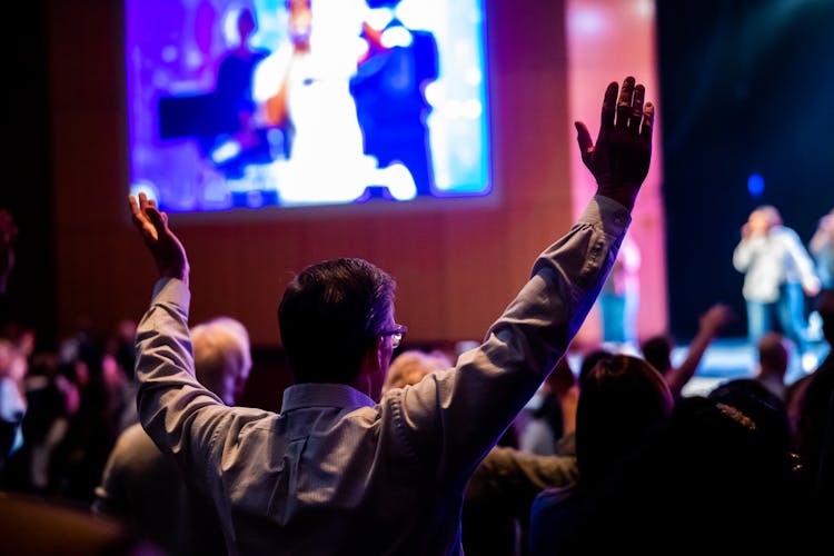 People With Arms Raised On Event