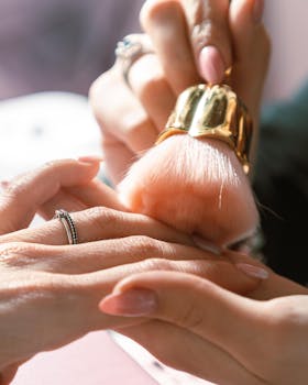 Close-up of a professional hand care session with a soft brush at a salon.