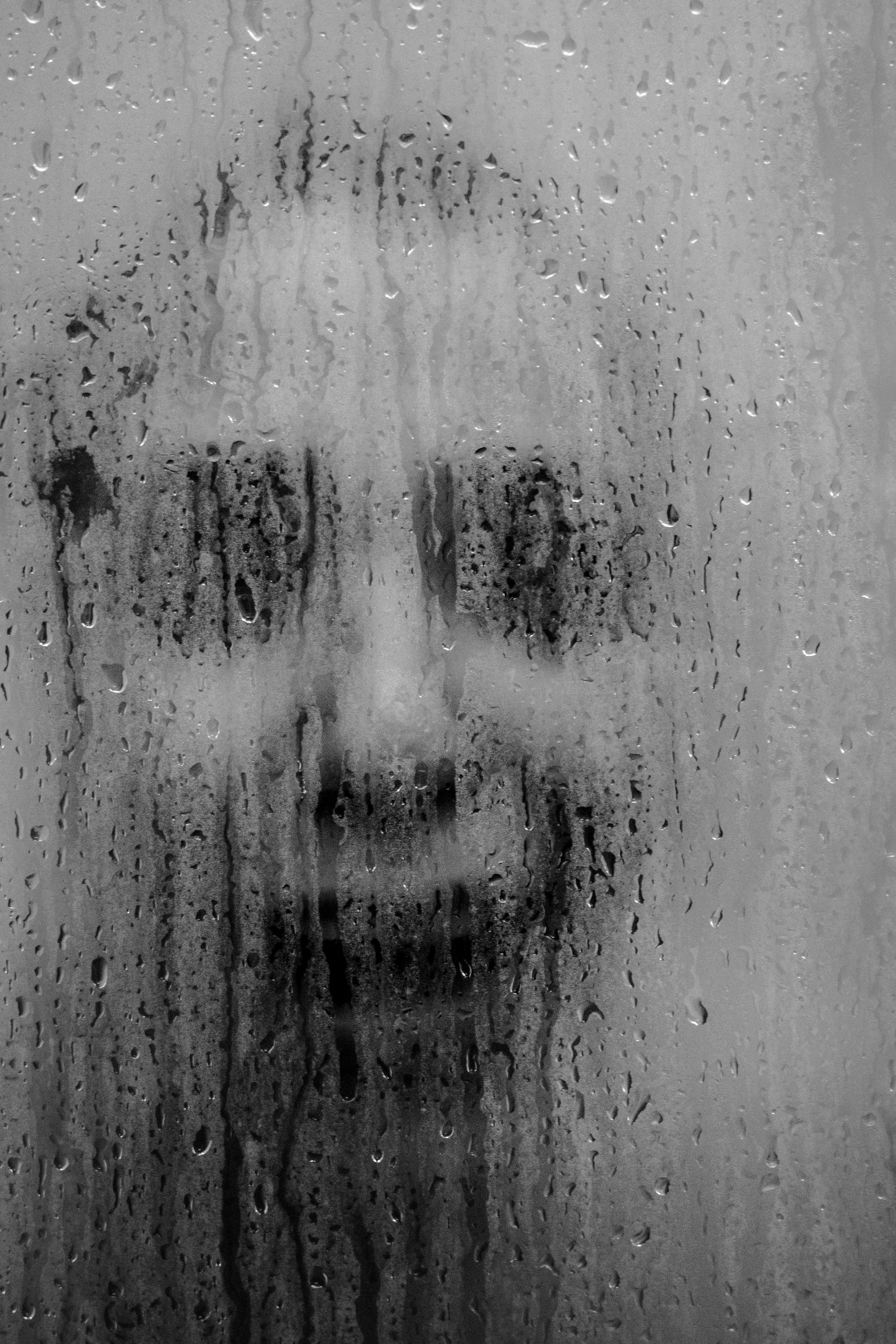 spooky person behind a wet shower door