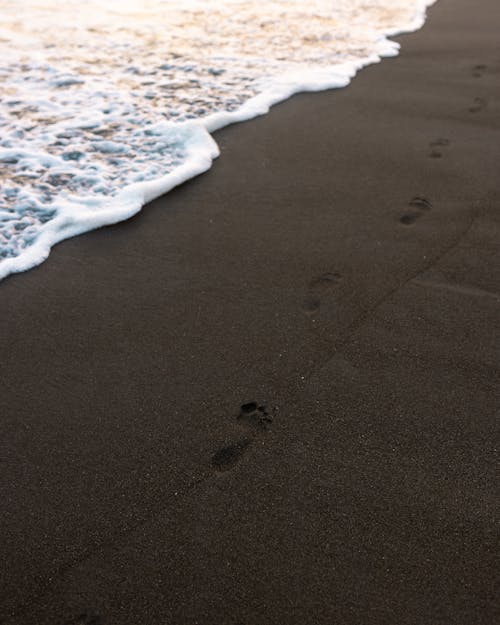 Footprints on a Black Beach