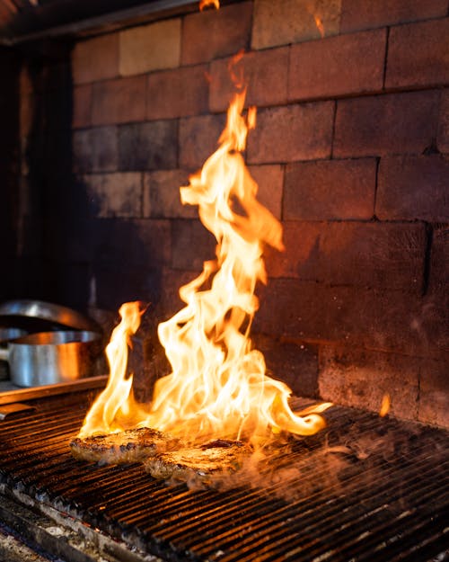 Stakes on Grill in Fire