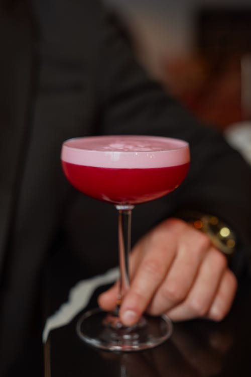 Close-up of a Man Holding a Red Cocktail 