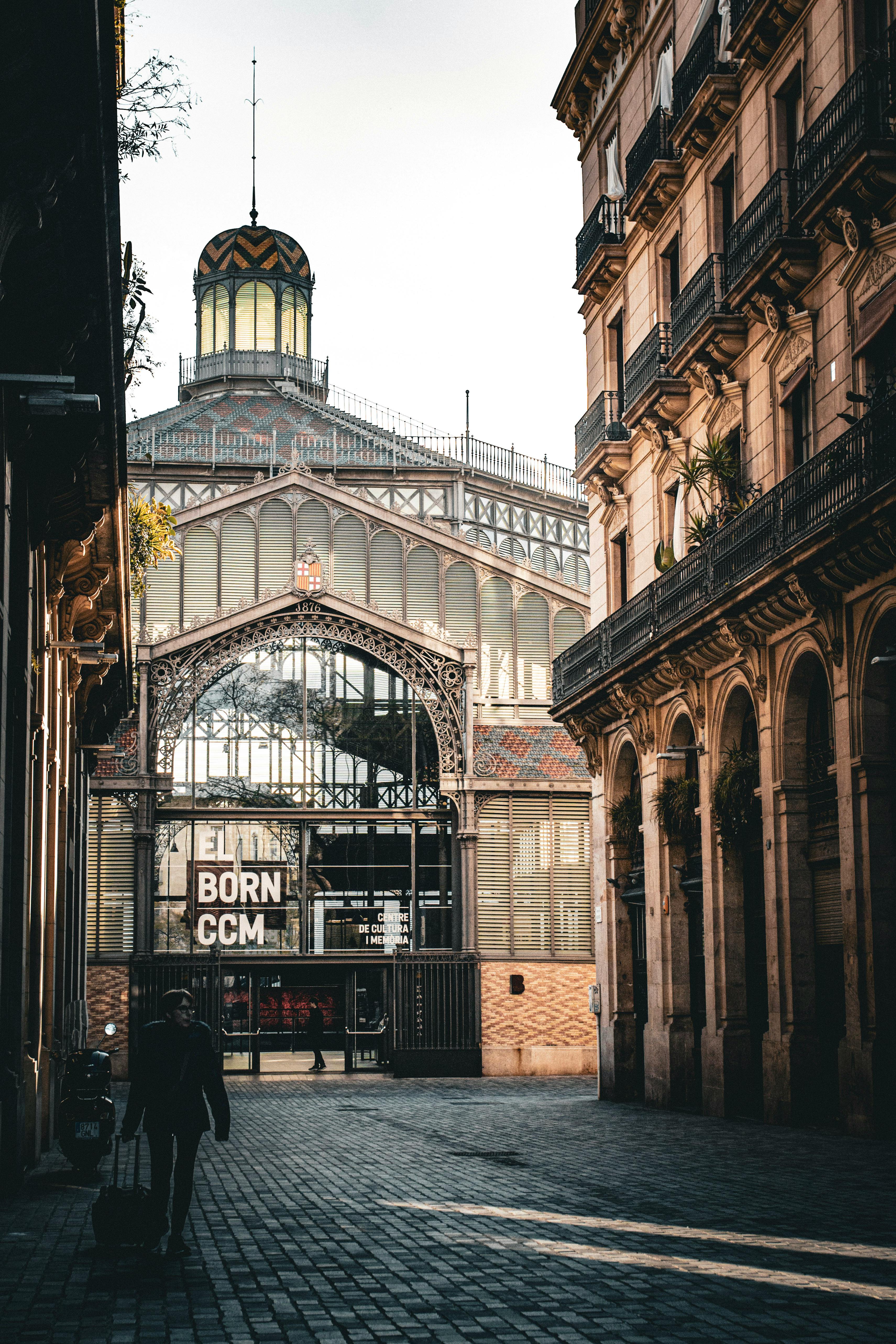 a man walking down a street with a building in the background