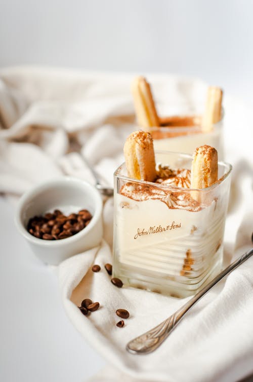 Photo of a Glass with Tiramisu and a Small Bowl of Coffee Beans