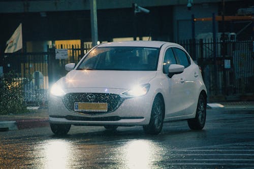 White Car Driving in the Rain 