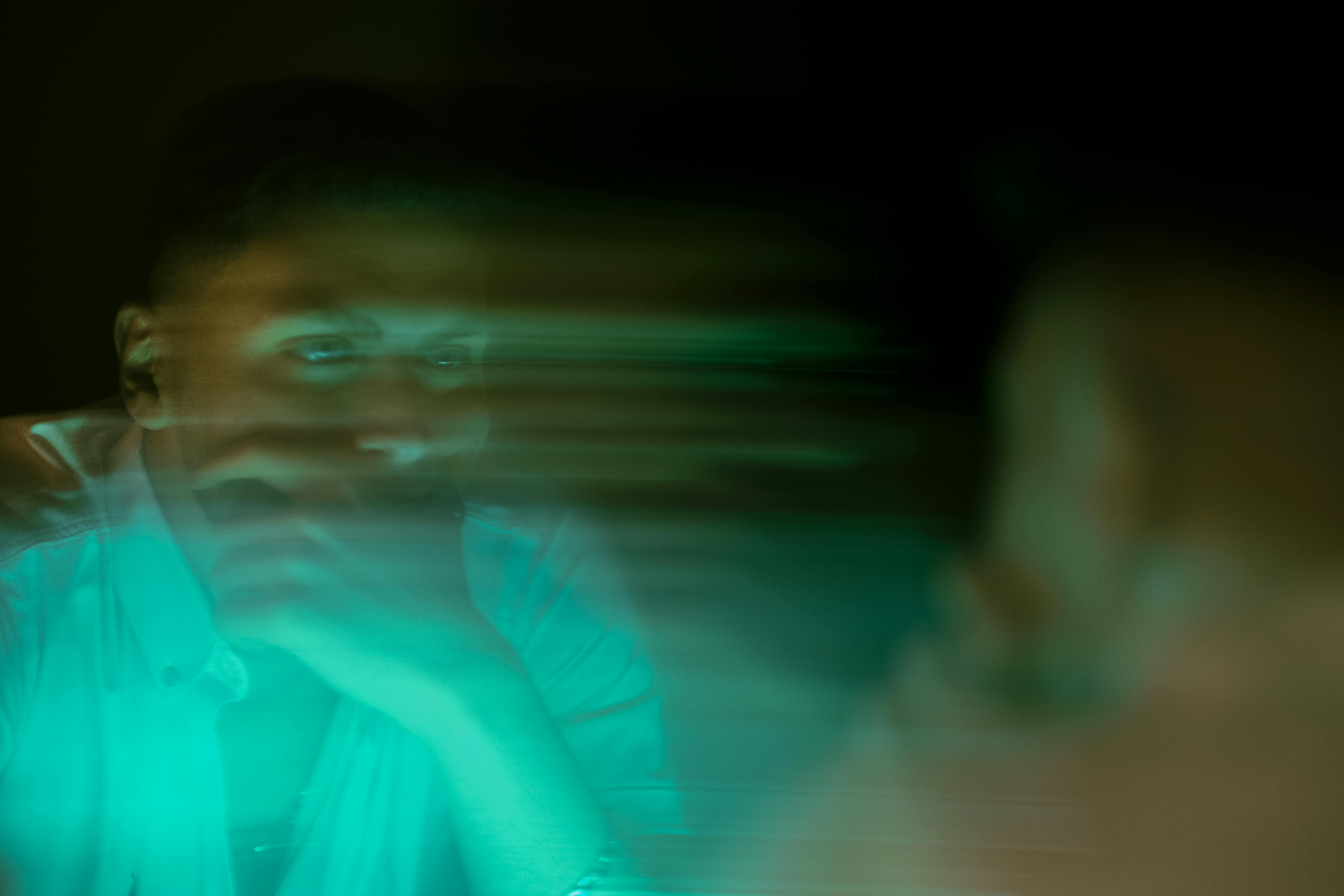 Abstract image of a man with blurred effects, symbolizing contemplation and motion.