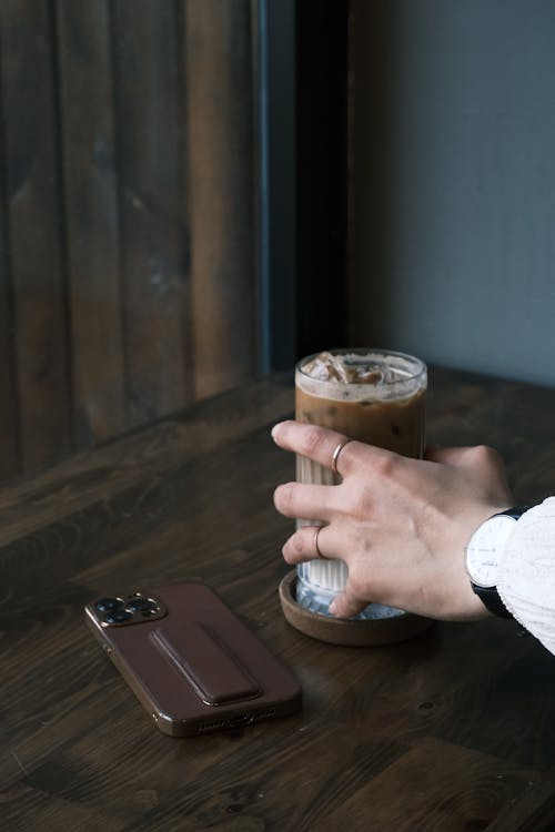 Woman Holding a Glass with Ice Coffee