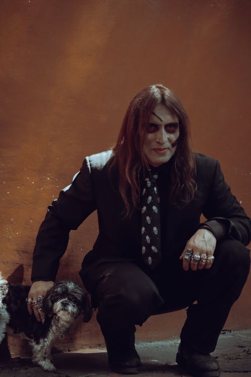 Free A man with Halloween makeup poses with a dog, showcasing spooky fashion style in Mexico City. Stock Photo