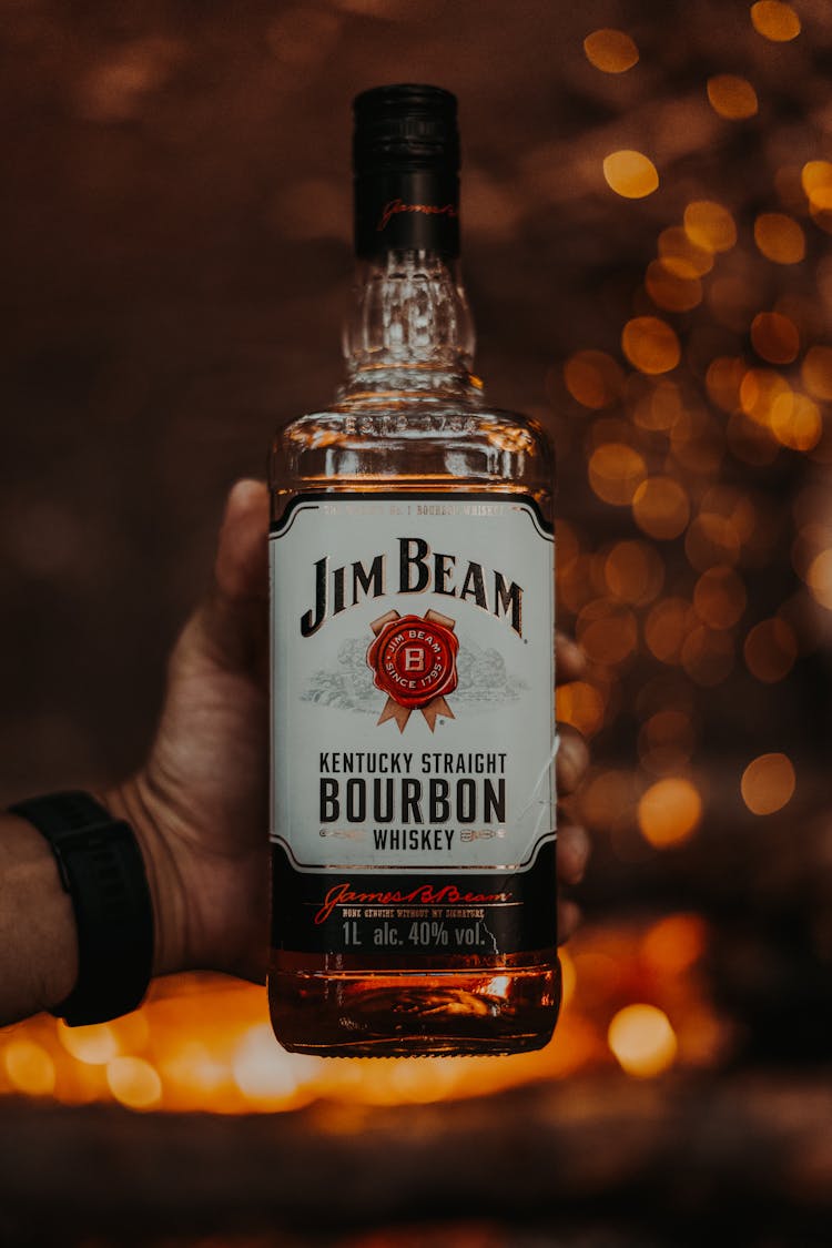 Hand Holding Bourbon Bottle