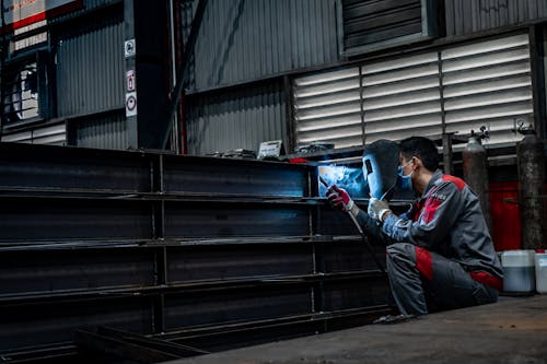 Welder Sitting and Working