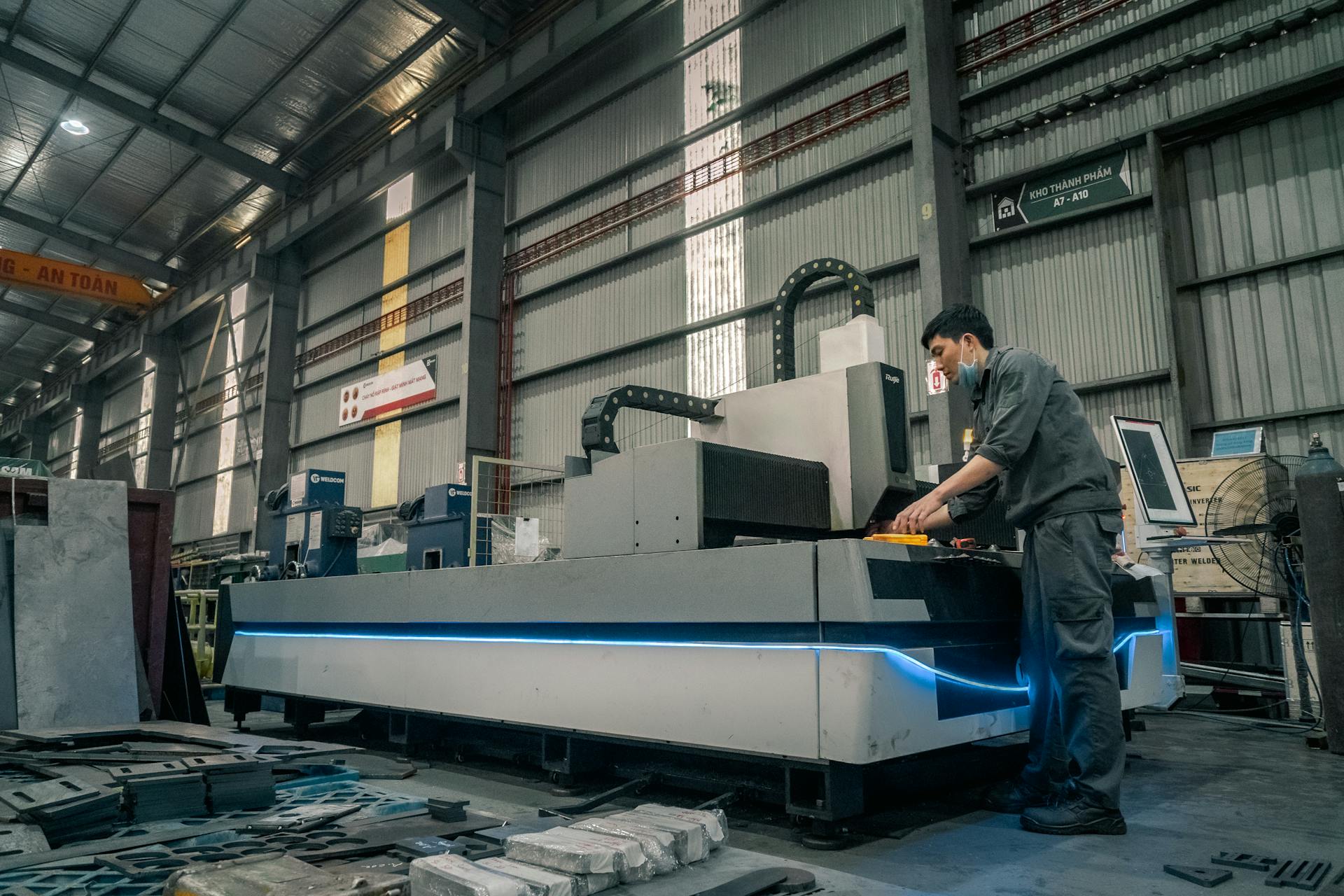 Man Standing and Working by Machinery