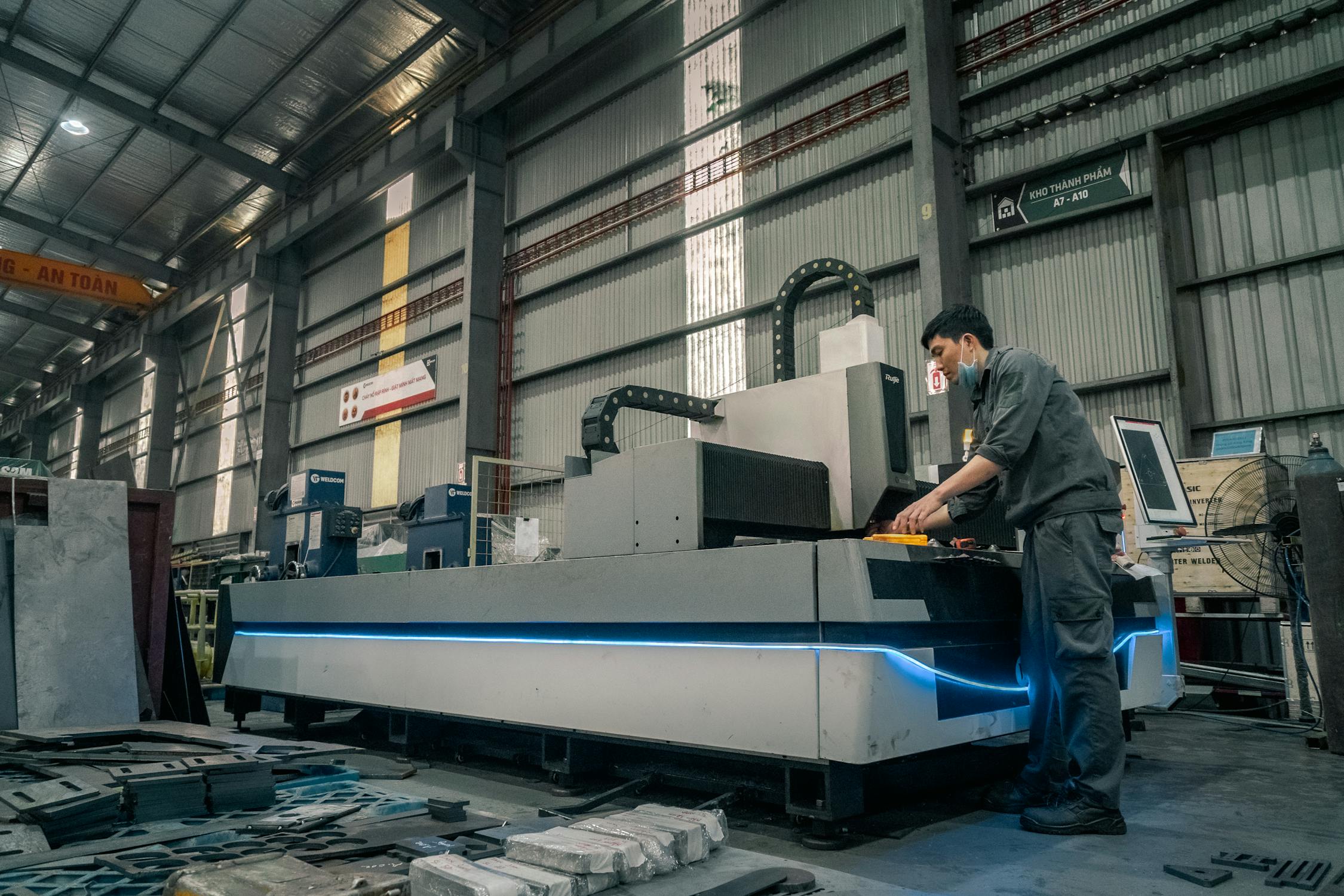 Man Standing and Working by Machinery · Free Stock Photo